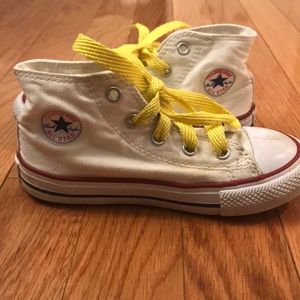 White converse high tops with yellow laces